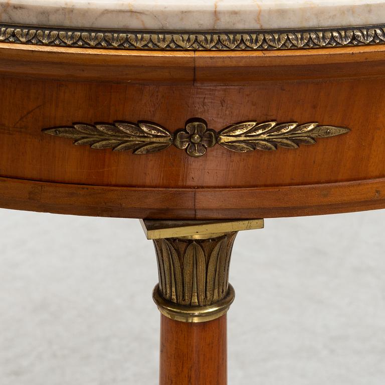 A table with marble top and brass mountings from around year 1900.