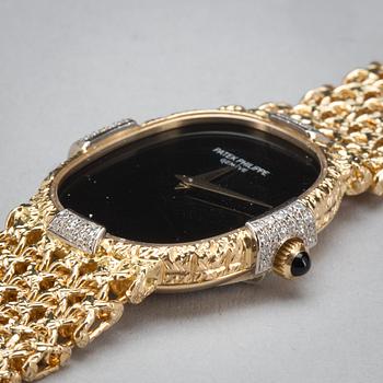 A Patek Philippe Golden Eclipse ladie's wristwatch set with brilliant-cut diamonds. Total carat weigt 0.15 ct. Onyx dial.