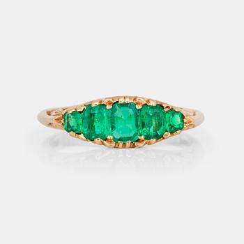 742. A ring with five step-cut emeralds.