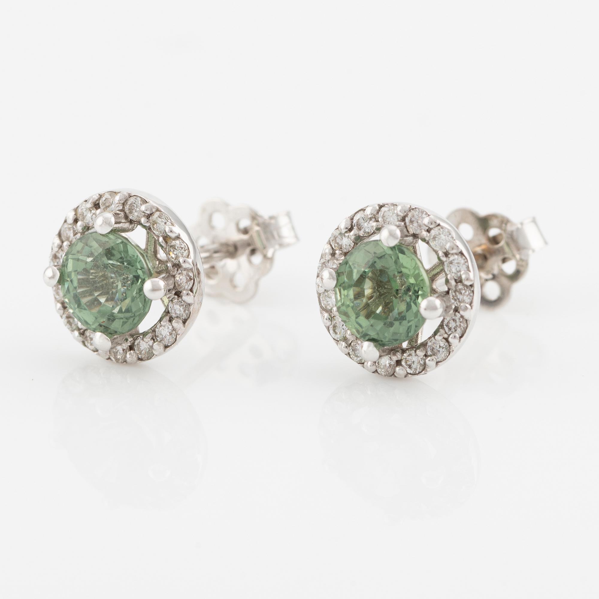 A pair of 18K gold earrings with green faceted sapphires and round brilliant-cut diamonds.