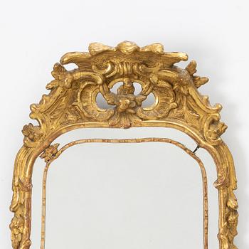 A gilt-gesso rococ-style mirror, 20th century.