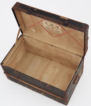 A late 19th century black trunk by Louis Vuitton.