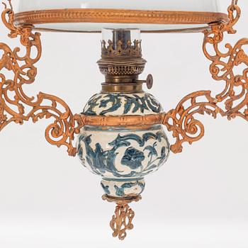 A ceiling carosene lamp, circa 1900.