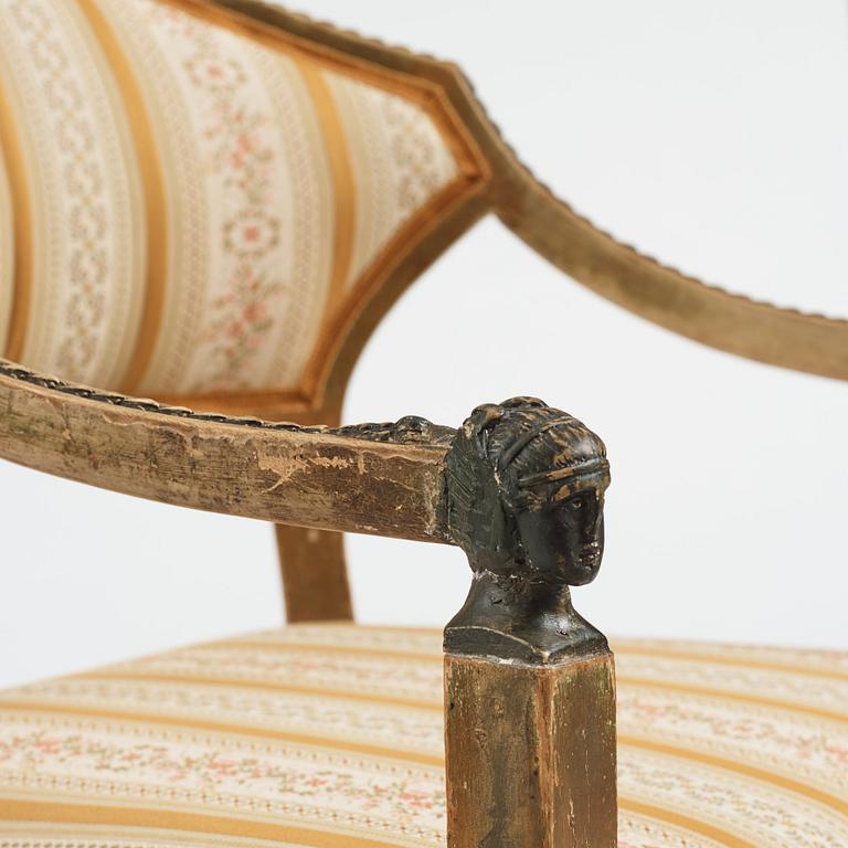 A Late gustavian armchair and stool in the manner of C G Gjörwll (1766-1837).