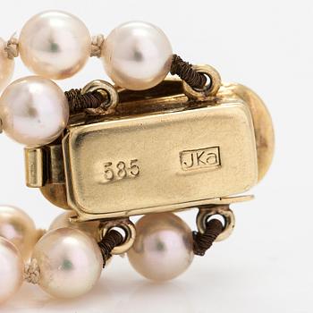 A 2-strand pearl bracelet with cultured pearls, lock 14K gold and diamonds, ca 0.13 ct in total.