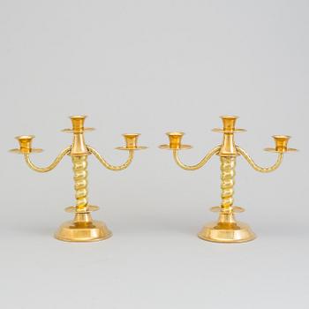 a pair of brass candelabras by Gottfrid Carlsson Eskilstuna.