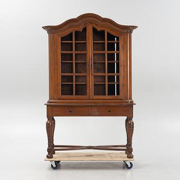 A rococo vitrine cabinet, 18th Century. On a later stand.