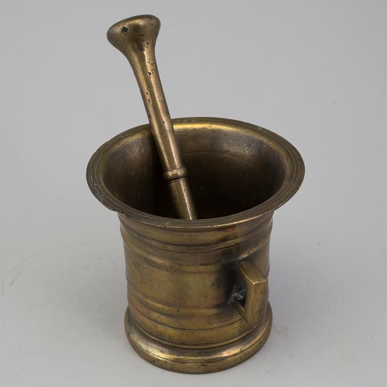 A 18th century brass mortar with pestle.