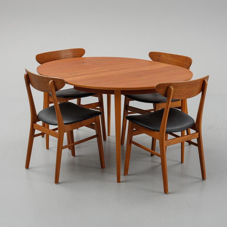 A teak dining table with 4 'Monaco' chairs, mid 20th century.