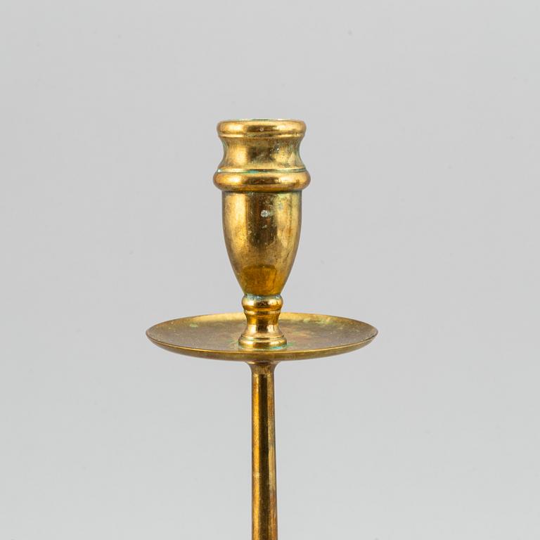 A pair of model 2539 brass candlesticks, for Firma Svenskt Tenn, designed ca 1949-50.