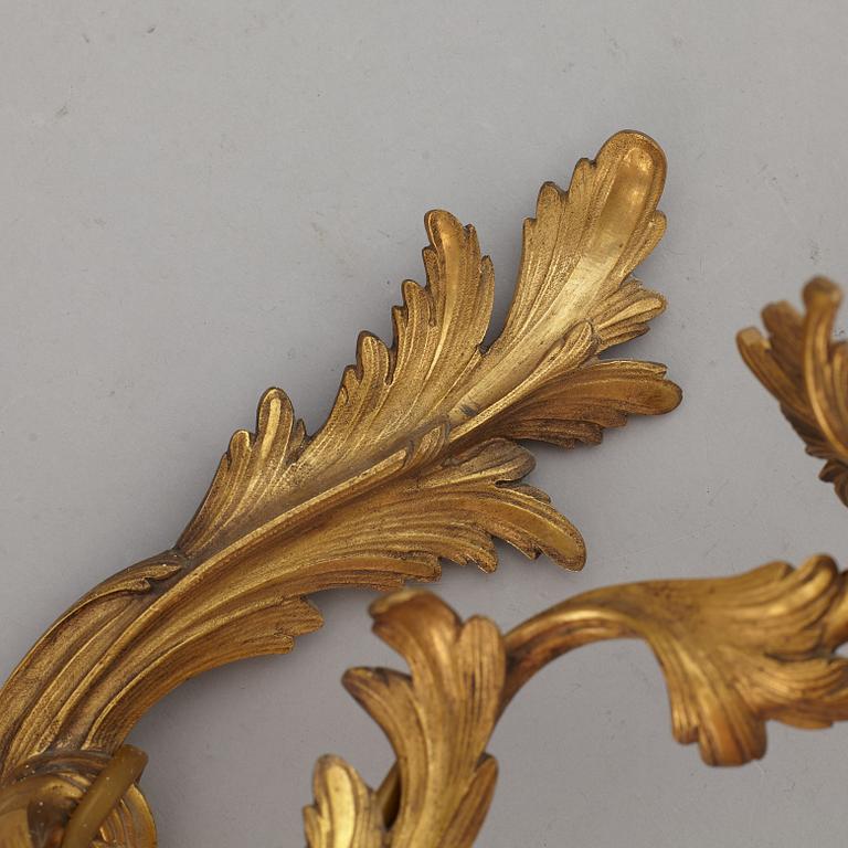 A pair of Louis XV style 20 th Century wall sconces.