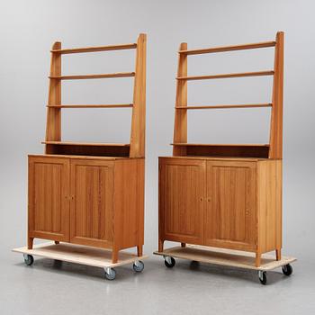 A pair of pine cupboards with shelves by Carl Malmsten.