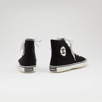 CHANEL, a pair of black canvas sneakers.