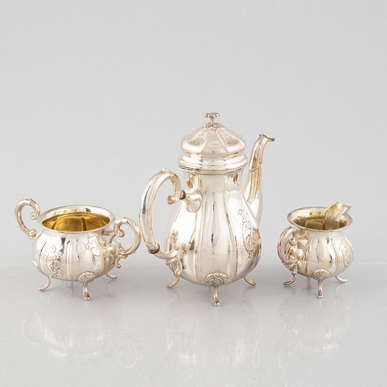 A Swedish Rococo Style Coffee Pot, Creamer and Sugar Bowl, mark of JE Skreij, Falun 1951-55.