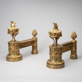 A pair of gilt brass Louis-XVI style andirons, second half of the 19th Century.