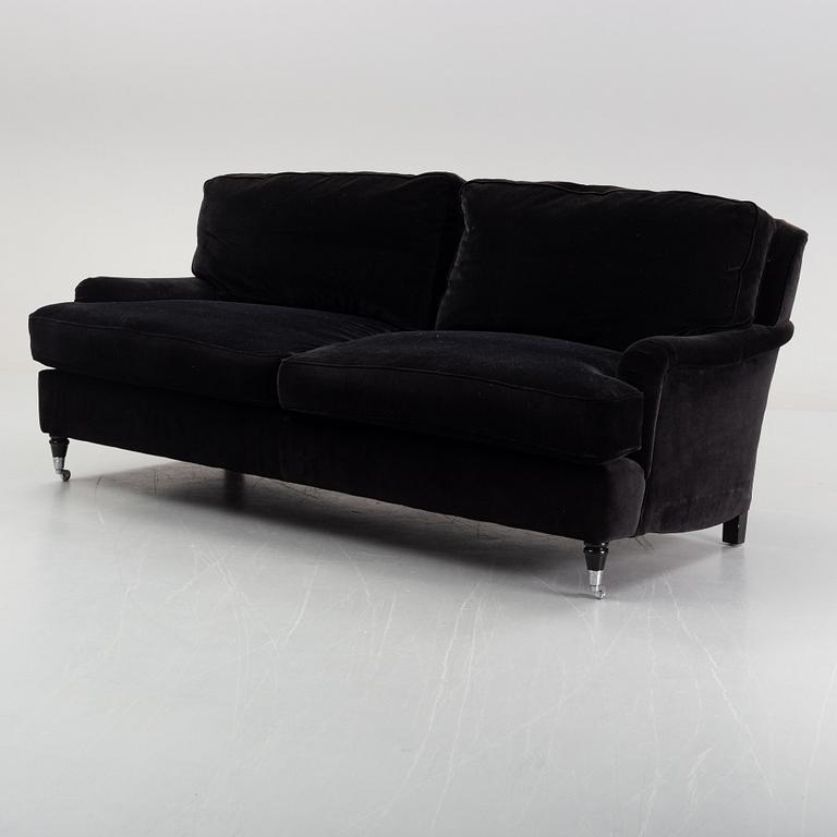 A contemporary velvet Howard sofa.
