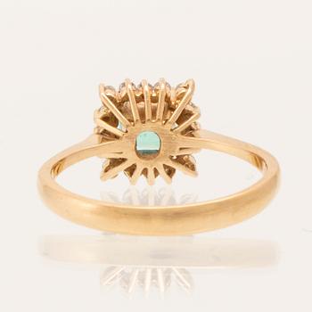 Ring in 18K gold with a step-cut emerald and round brilliant-cut diamonds.