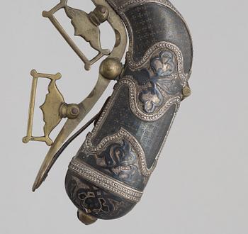 A Caucasian priming flask.