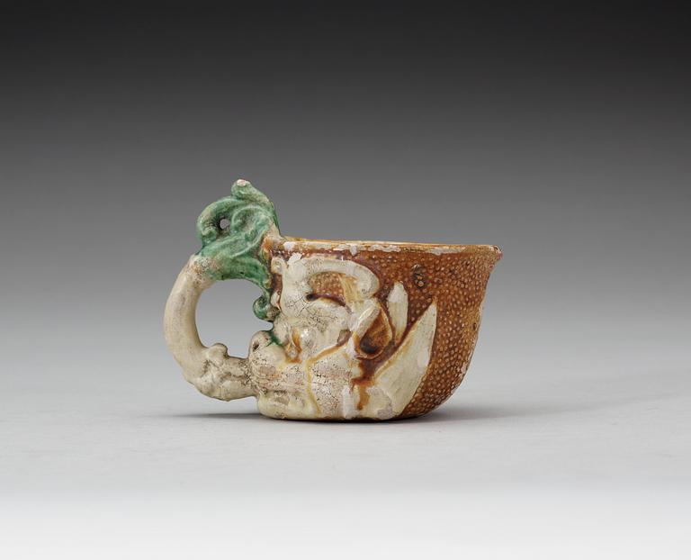 A green white and yellow glazed rhyton ewer, Tang dynasty (618-907).