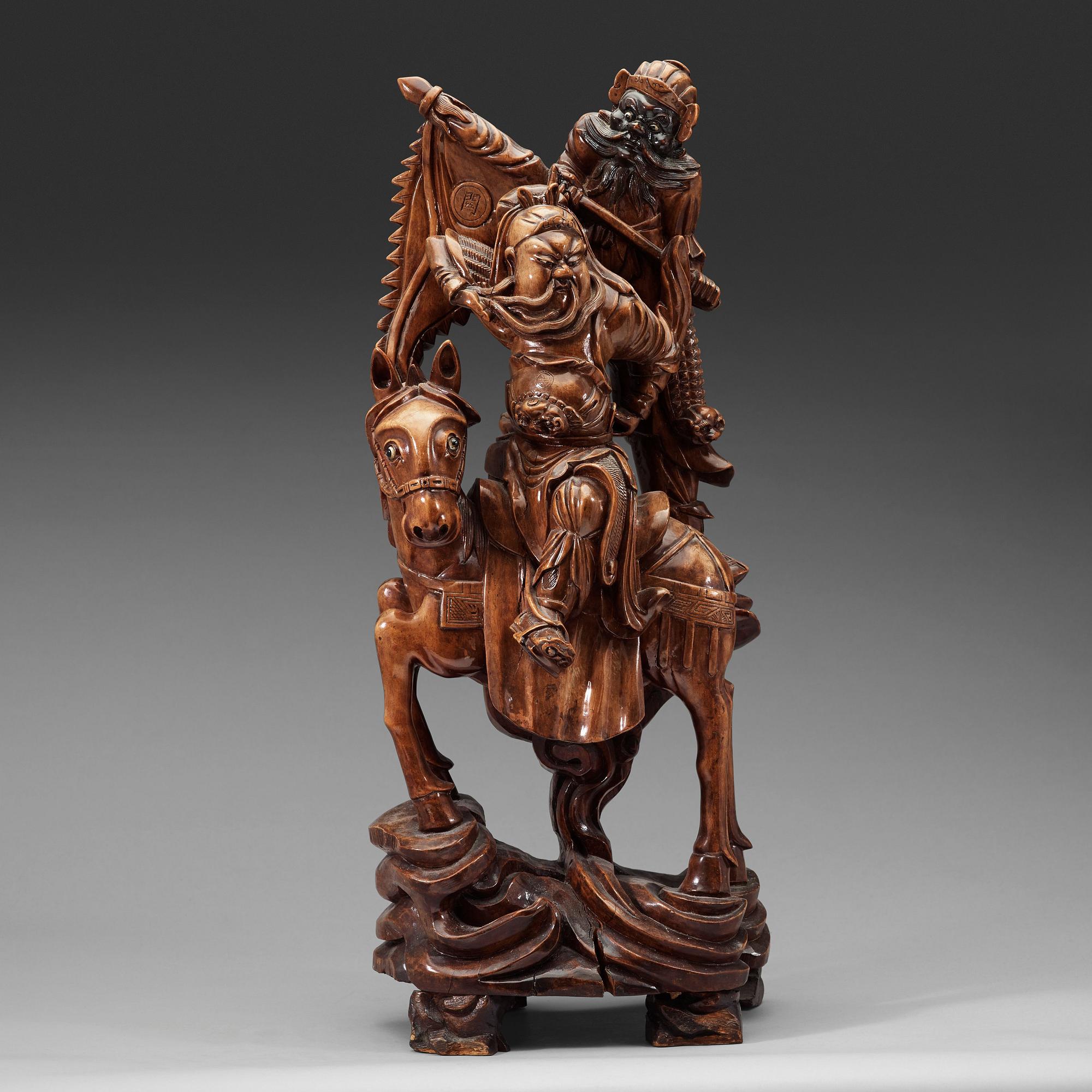 A large wooden sculpture group of Guandi on horseback and an attendant, Qing dynasty (1644-1912).