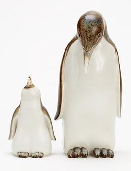 Two Gunnar Nylund stoneware figures depicting a penguin mother with child, Rörstrand.