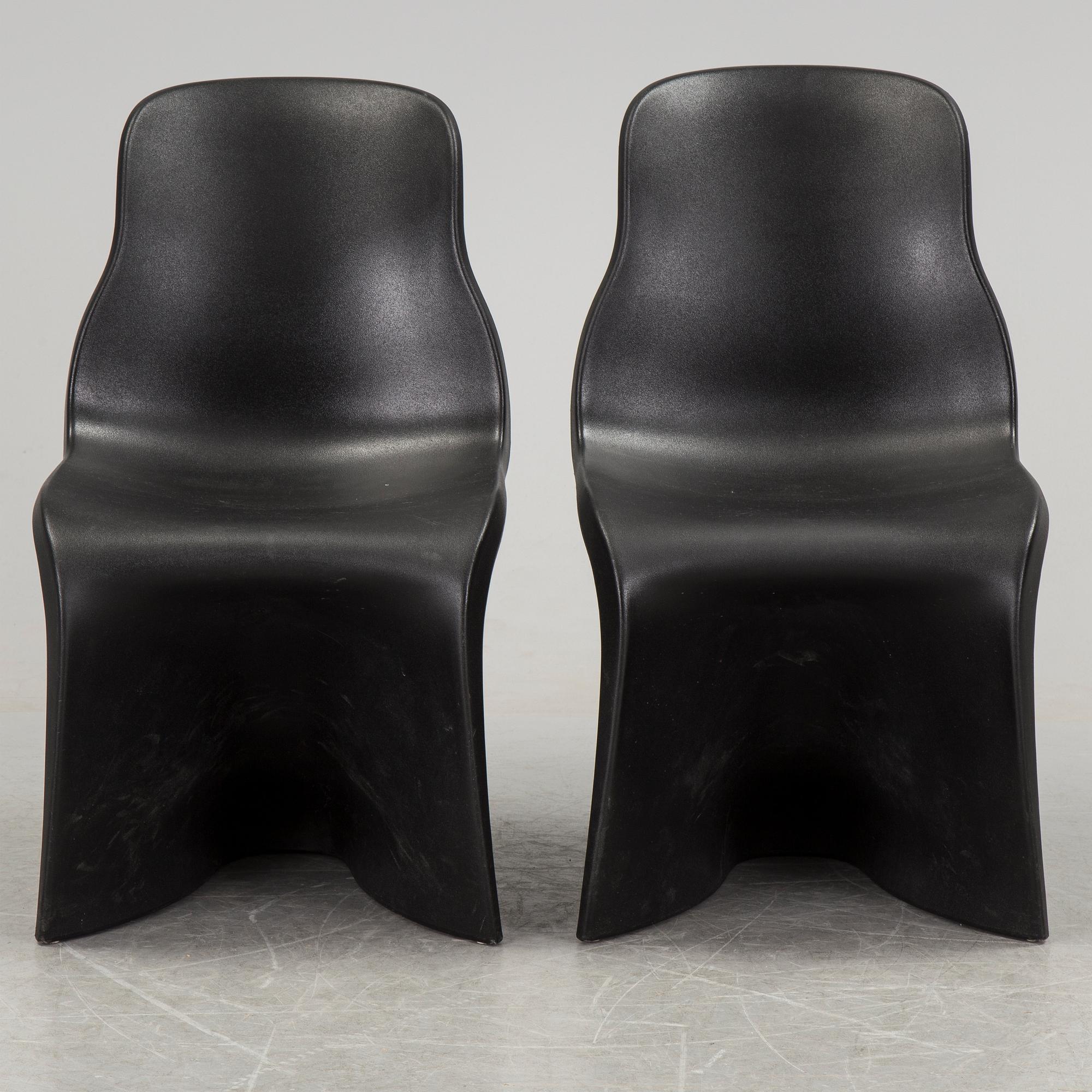 a pair of Italian black plastic chairs designed by Fabio Novembre "Him" and "Her" from the late 20th Century.