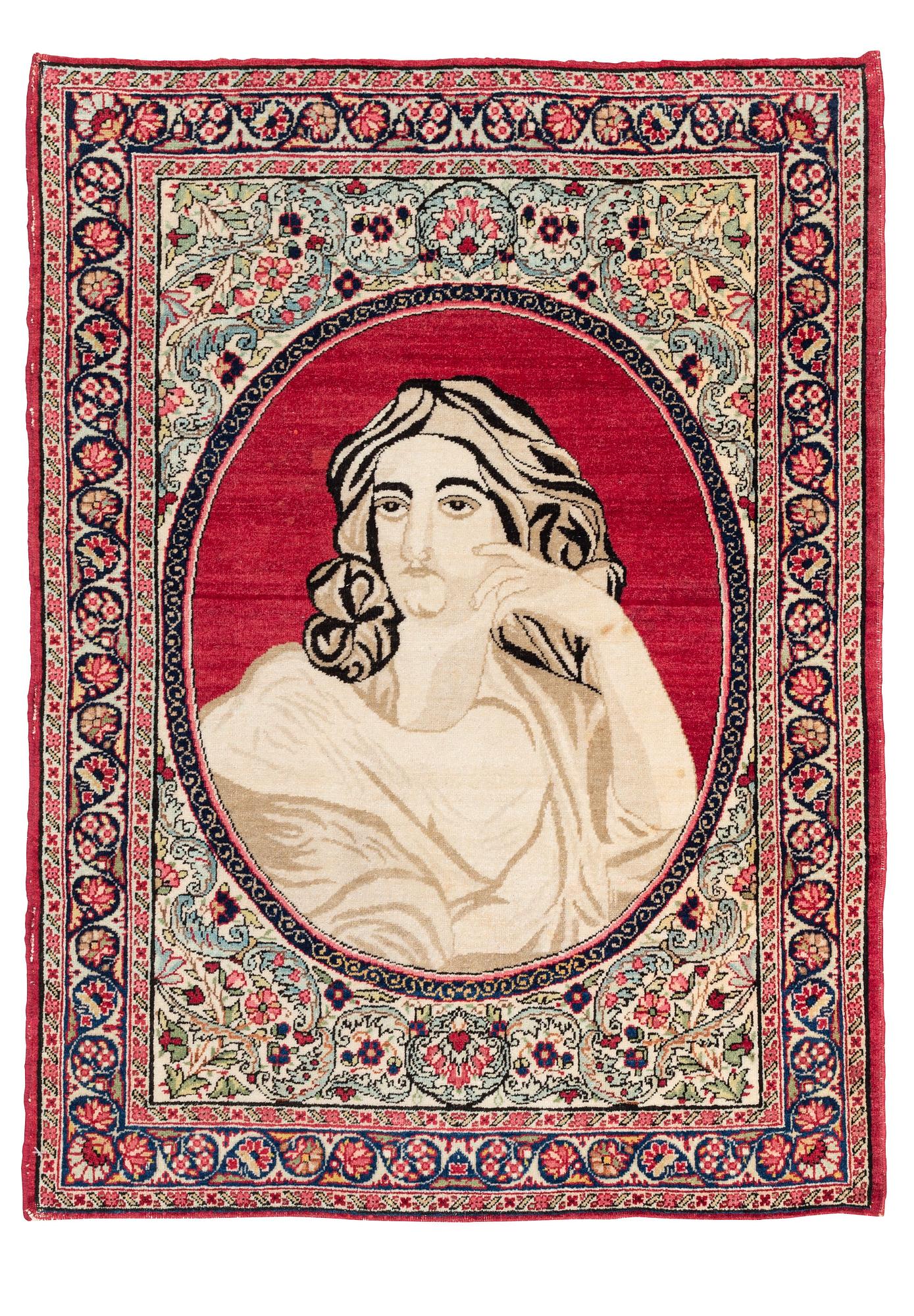 An antique pictoral Kerman Raver rug, c. 87 x 65 cm.