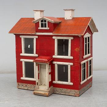 a dolls cabinet, dated 1940.