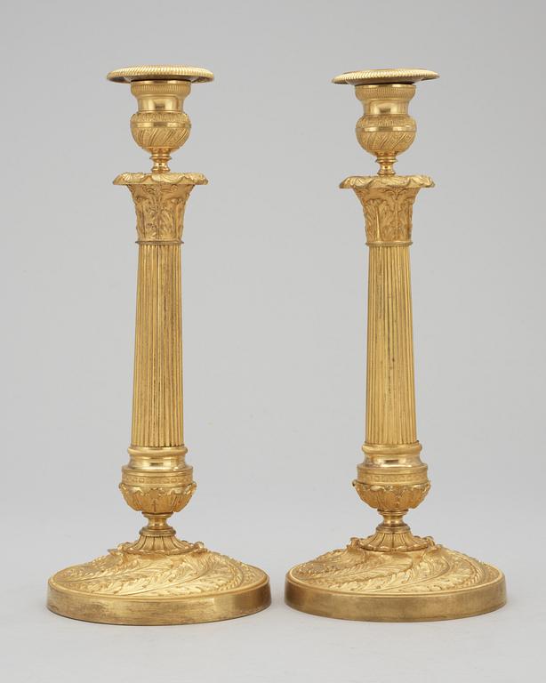 A pair of French Empire early 19th century candlesticks.