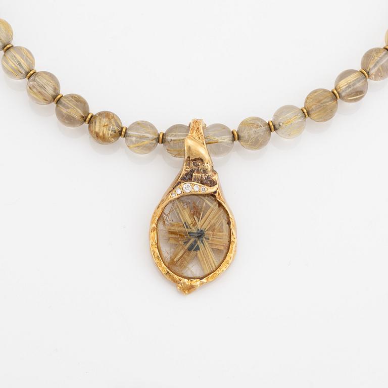 Arne Blomberg, pendant with chain, rutile quartz, gold and diamonds.