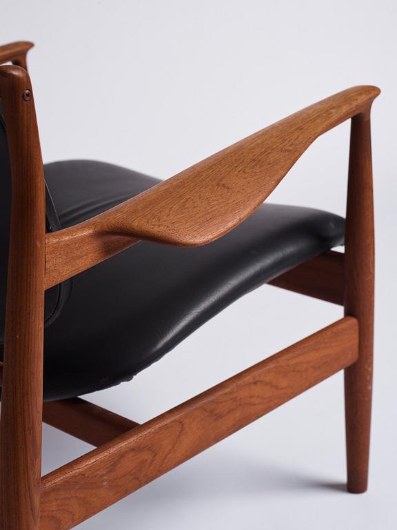 Finn Juhl, a teak and black leather 'model 136' easy chair, France & Daverkosen, Denmark 1950-60s.