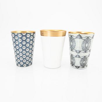 Åsa Lindström,  a set of three signed porcelain mugs.