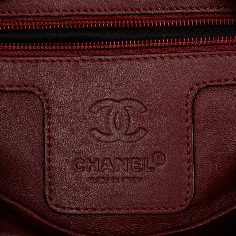 CHANEL, a quilted black mens messenger bag.