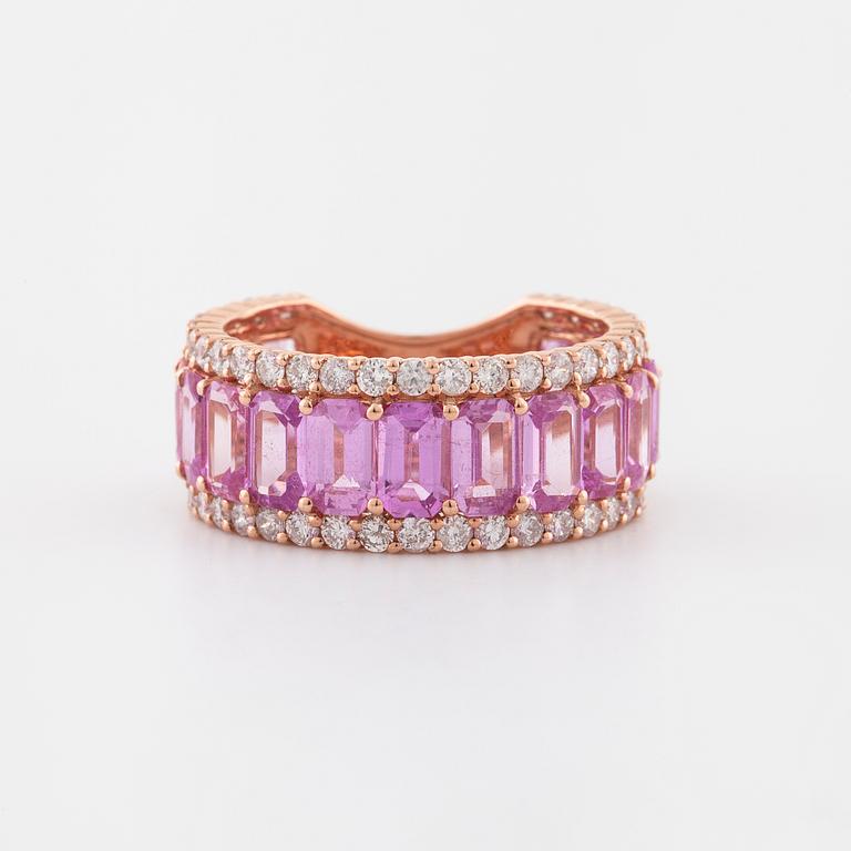 An emerald cut pink sapphire and brilliant cut diamond ring.