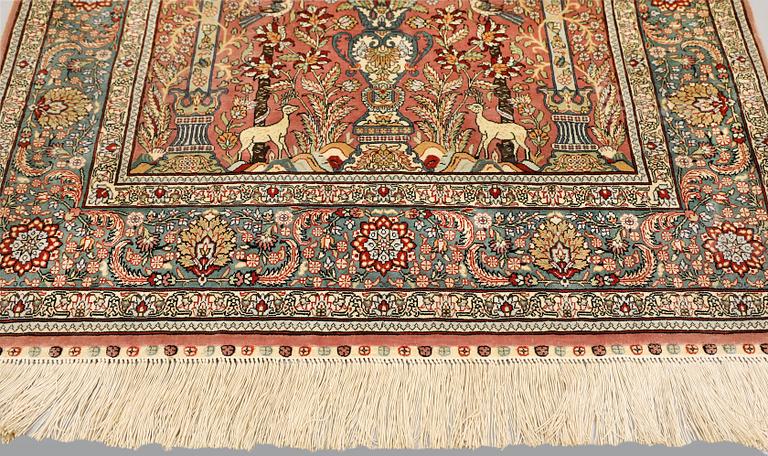 An oriental silk rug, approx. 155 x 93 cm.