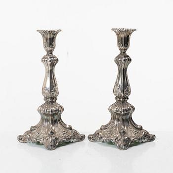 A pair of rococo-style silver candle sticks, early 20th century.