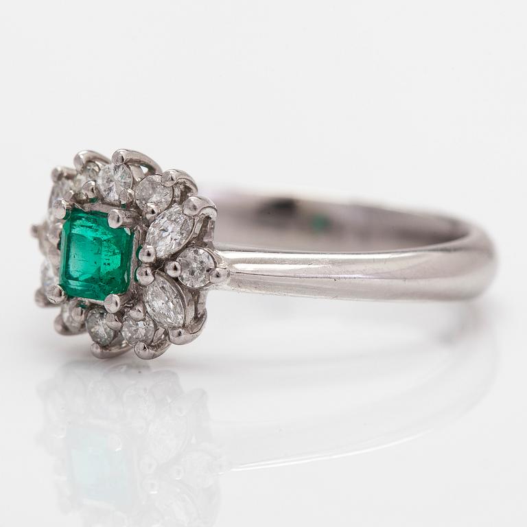 A platinum ring, with an emerald and brilliant- and marquise-cut diamonds.