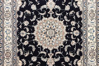 A Nain carpet, part silk, c. 303 x 200 cm.