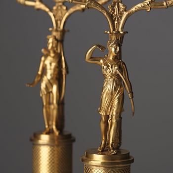 A pair of French Empire two-light gilt bronze candelabra, early 19th century.