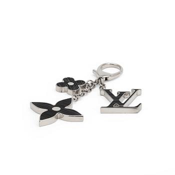 LOUIS VUITTON, a palladium finished brass and black bag charm, "Fleur d'epi".