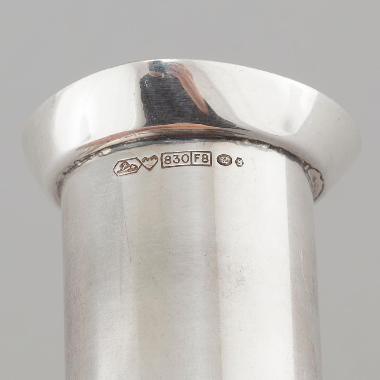 Two silver drink accessories with finnish stamps.