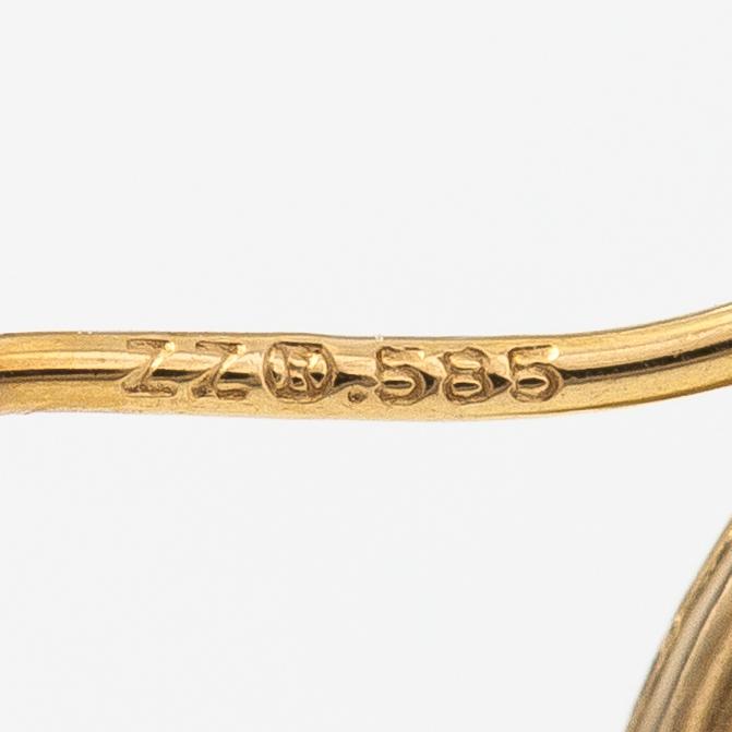 A pair of 14K gold earrings.