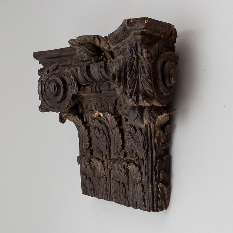 An 18th/19th century carved wood corinthian capital.