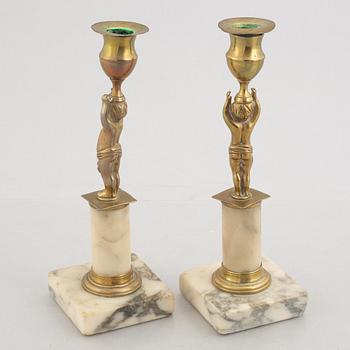 A pair of late Gustavians marble and brass candlesticks, circa 1800.