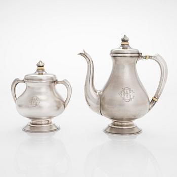 A four-piece silver coffee set, St. Petersburg 1887, original fitted box from Khlebnikov. Sugar tong, Moscow around 190.