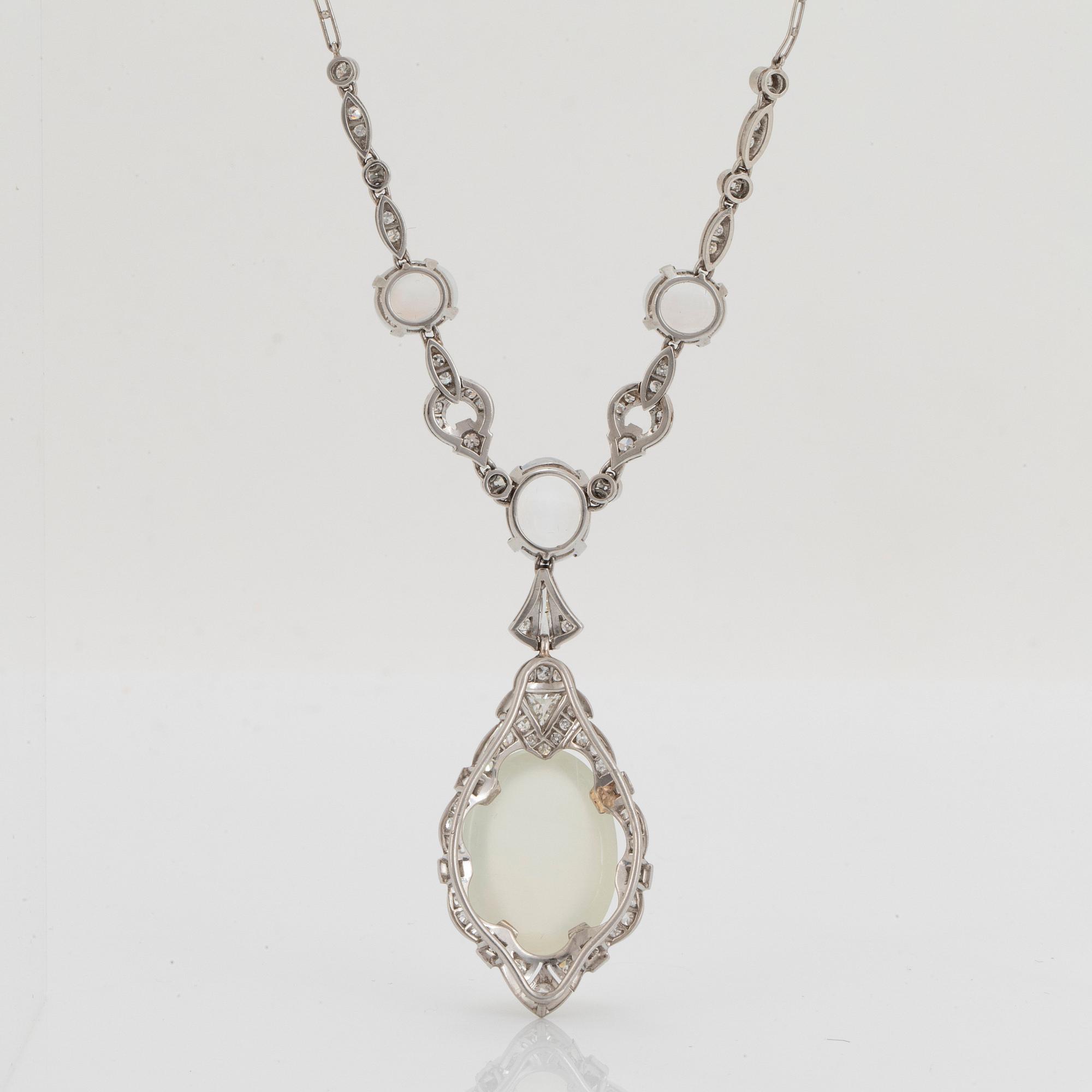 A platinum necklace set with moonstones and old- and eight-cut diamonds.