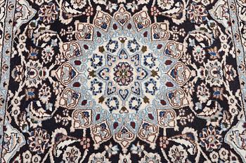 A Nain rug, part silk, 9 laa, c. 210 x 119 cm.