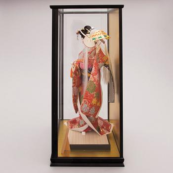 A latter half of the 20th century Japanese doll in showcase.