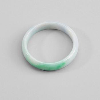 204. A white and green jadeite bangle with traces of lavender colour, China, 20th Century.