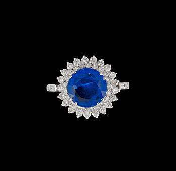 An untreated sapphire, 4.31 cts, surrounded by diamonds, total carat weight circa 1.30 cts.